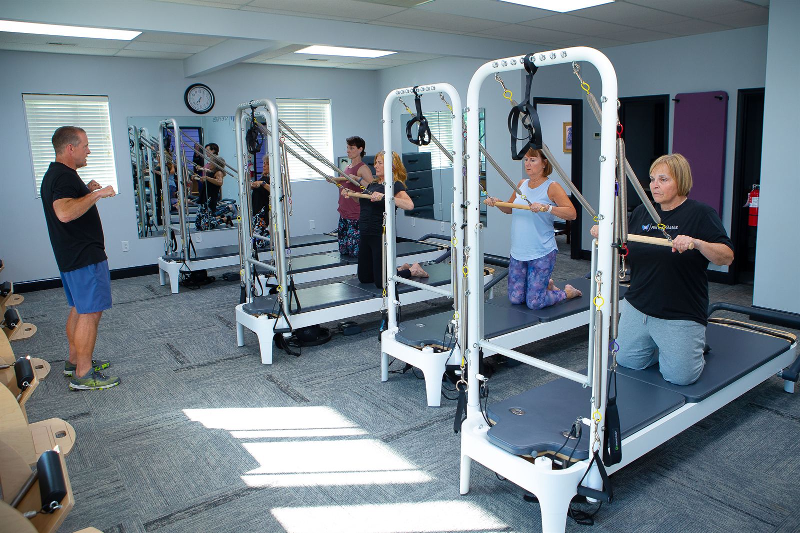 Tower class working through a kneeling series at Parks Pilates